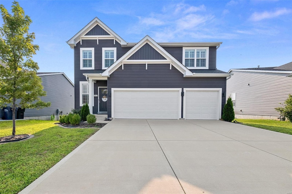 view of front of house with a front lawn and a garage