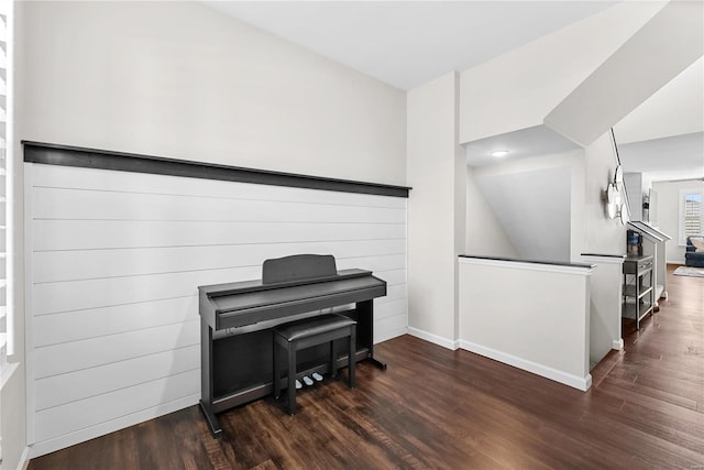 misc room with vaulted ceiling and dark wood-type flooring