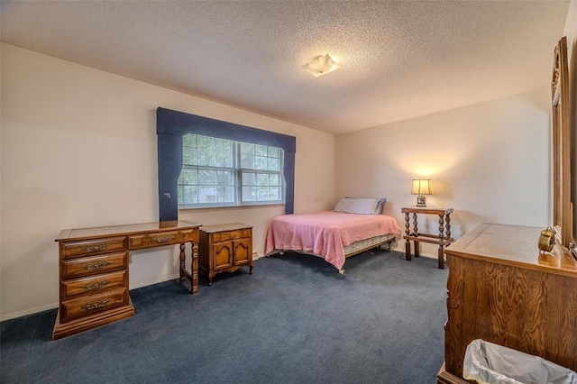 carpeted bedroom featuring a textured ceiling