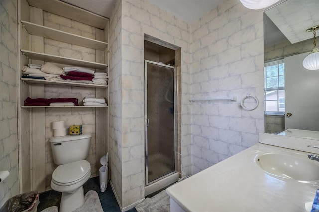 bathroom featuring vanity, toilet, and an enclosed shower