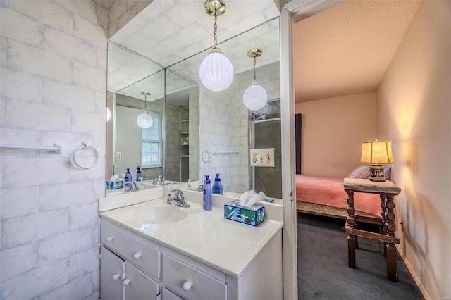 bathroom with walk in shower and vanity