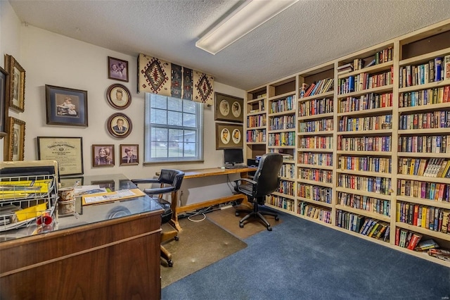 office area featuring a textured ceiling and carpet