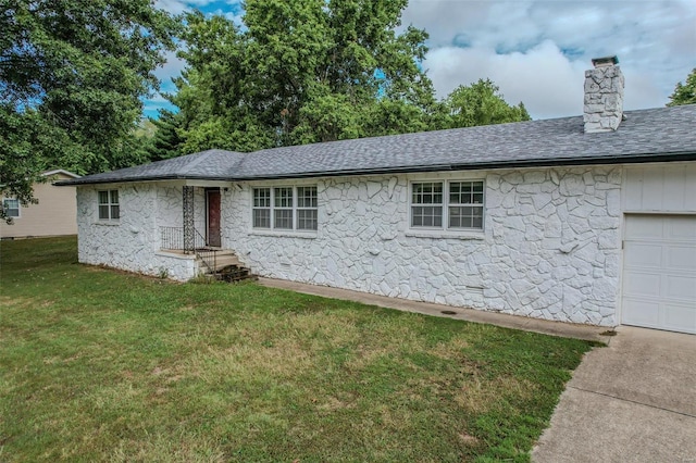 view of side of property with a garage and a yard