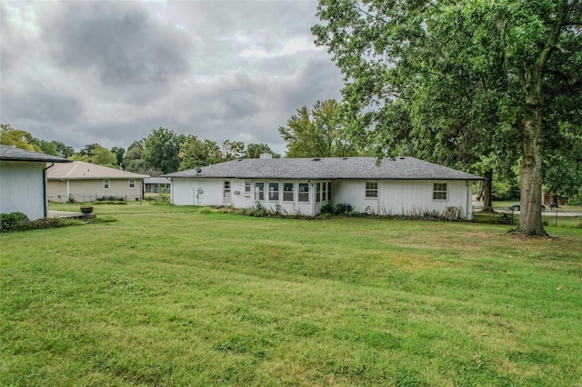 back of property with a lawn