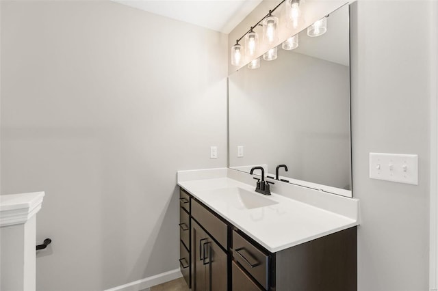 bathroom with vanity and baseboards