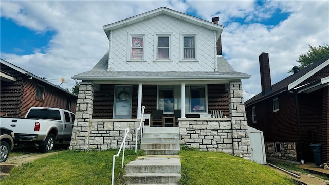 view of front of house with a front lawn and covered porch