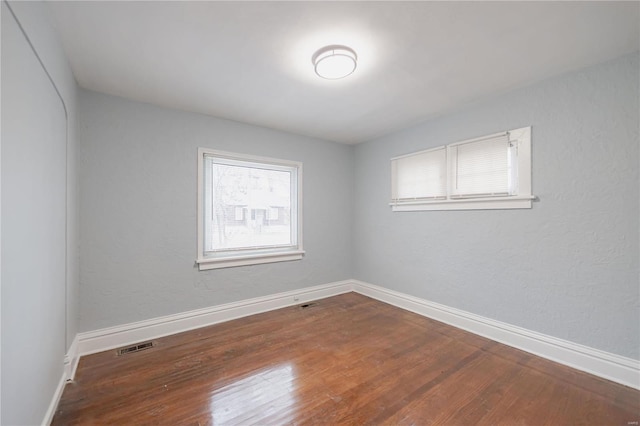 empty room with hardwood / wood-style floors