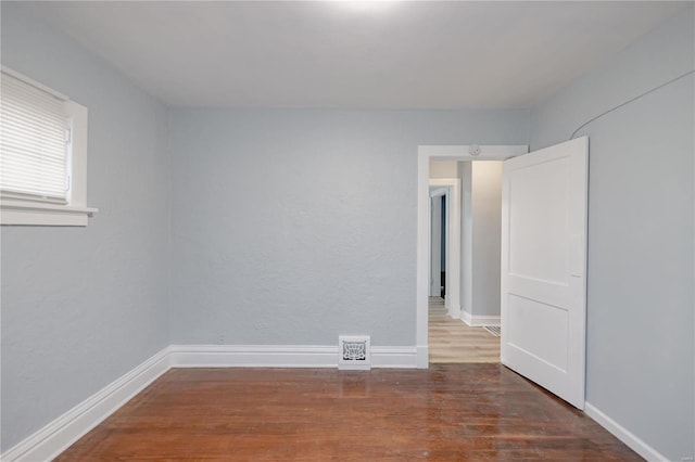 spare room with dark wood-type flooring