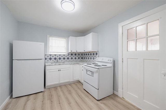 kitchen with decorative backsplash, white cabinets, white appliances, light wood-type flooring, and sink