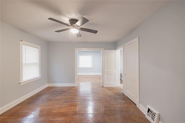 unfurnished room featuring ceiling fan and dark hardwood / wood-style floors