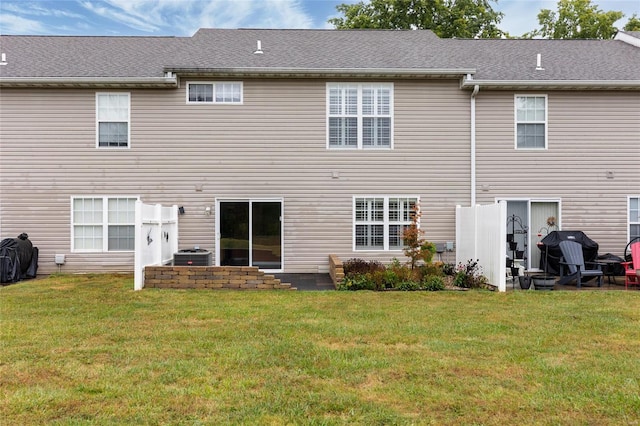 back of house featuring a patio, a yard, and central air condition unit