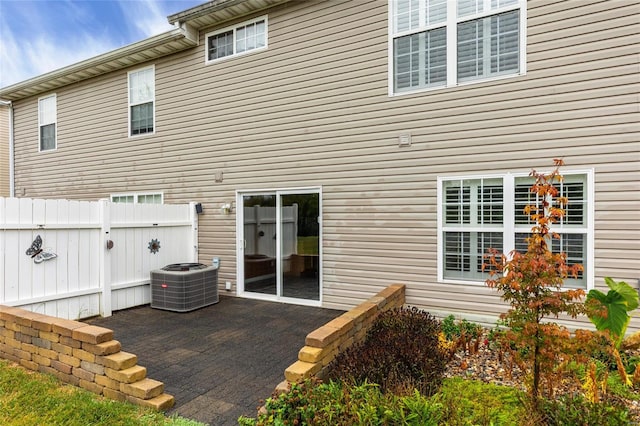 rear view of house with a patio and central AC unit