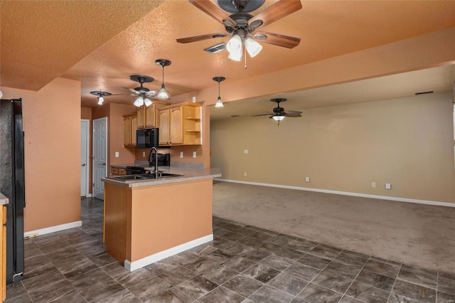 kitchen with black appliances, kitchen peninsula, light brown cabinetry, and ceiling fan