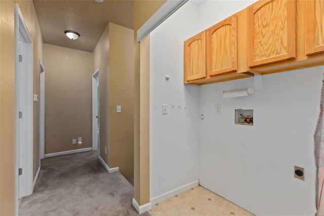 washroom with hookup for an electric dryer, a textured ceiling, gas dryer hookup, cabinets, and hookup for a washing machine