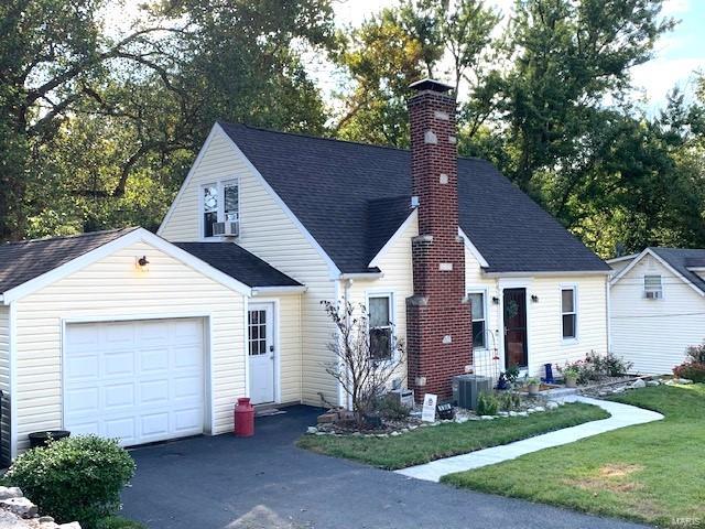 view of front of home featuring a front yard and central air condition unit