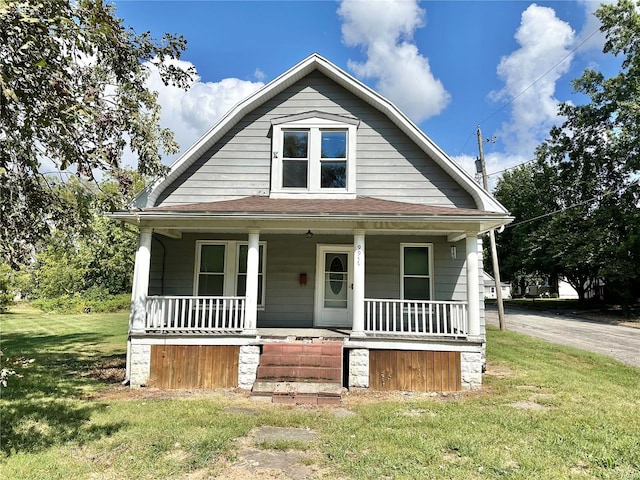 bungalow-style house featuring a porch and a front yard