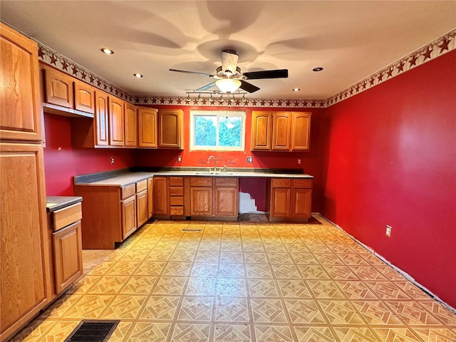 kitchen featuring ceiling fan and sink