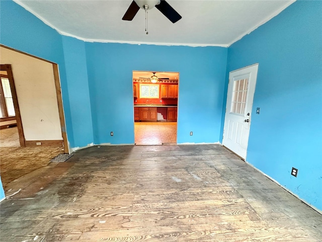 empty room featuring crown molding and ceiling fan