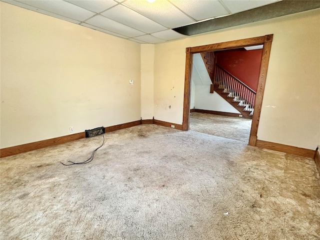 spare room with a drop ceiling and carpet flooring