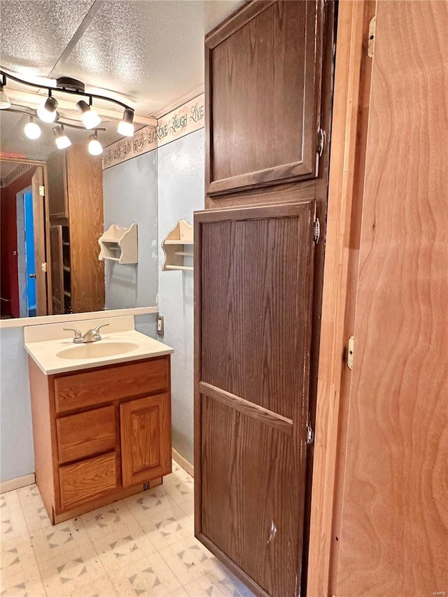 bathroom with a textured ceiling and vanity