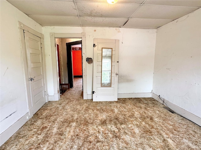 spare room featuring carpet floors and a paneled ceiling