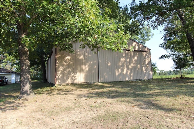 exterior space with a lawn and an outdoor structure