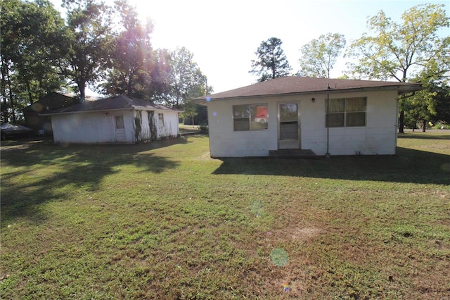 back of property featuring a lawn