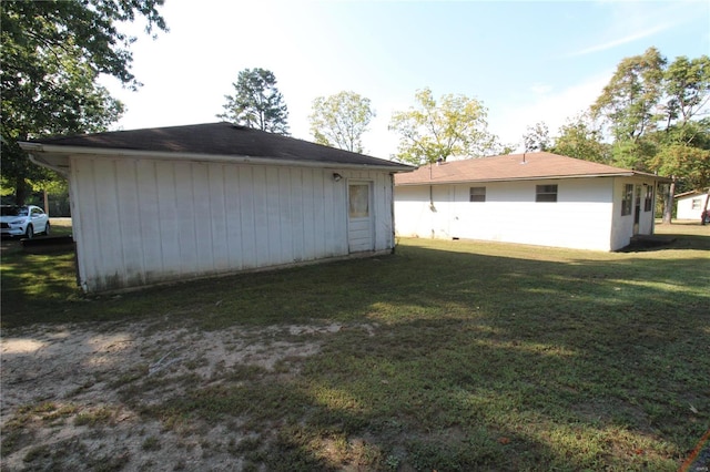 back of property featuring a lawn