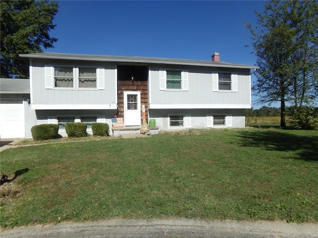 split foyer home featuring a front yard and an attached garage