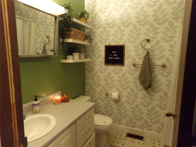 bathroom with tile patterned flooring, toilet, vanity, visible vents, and baseboards