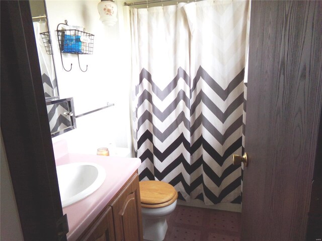 bathroom featuring toilet, a shower with curtain, and vanity