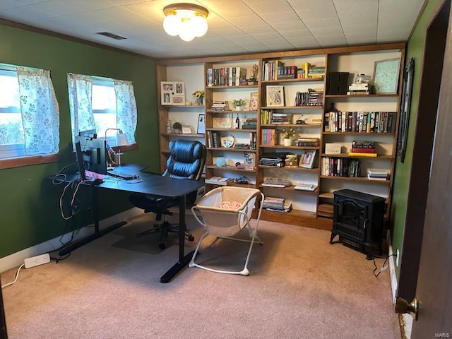 carpeted office space featuring visible vents and ornamental molding