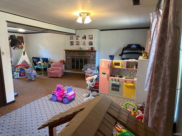 playroom featuring carpet floors and a fireplace