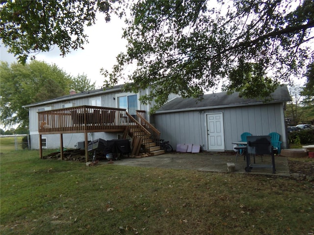 back of house featuring a deck, a yard, stairway, and a patio