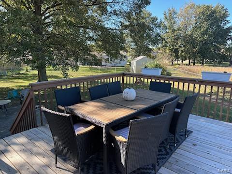 wooden terrace with outdoor dining area