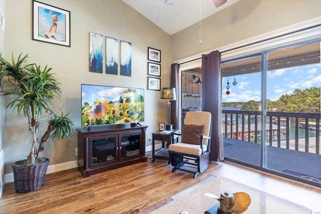 living room featuring lofted ceiling, hardwood / wood-style floors, and ceiling fan