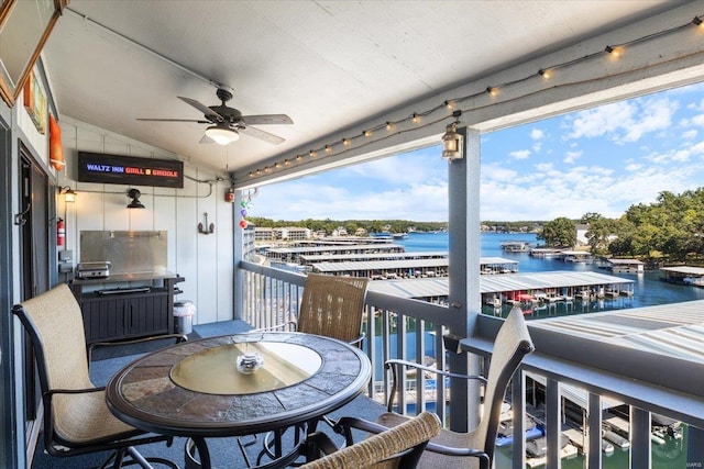 exterior space featuring ceiling fan and a water view