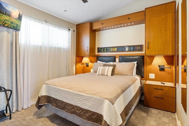 bedroom with light carpet, lofted ceiling, ceiling fan, and a textured ceiling