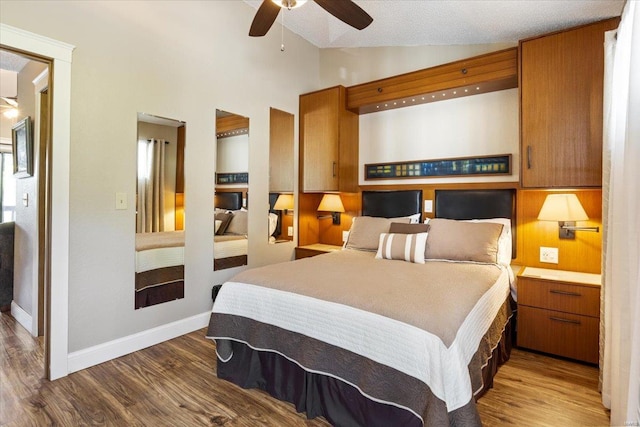 bedroom featuring ceiling fan, dark hardwood / wood-style floors, and vaulted ceiling