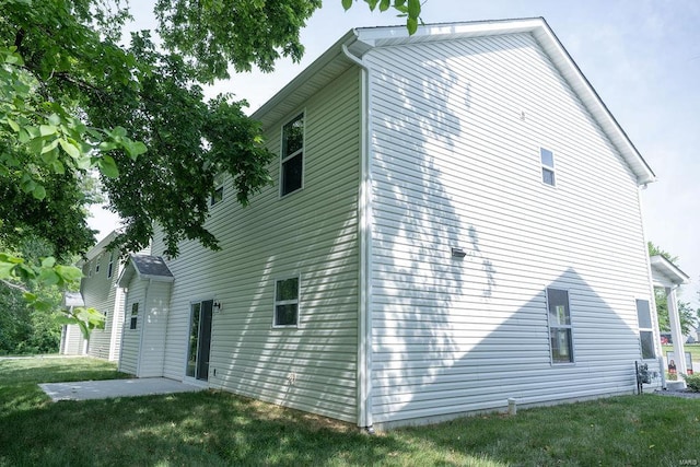 view of property exterior featuring a patio area and a yard