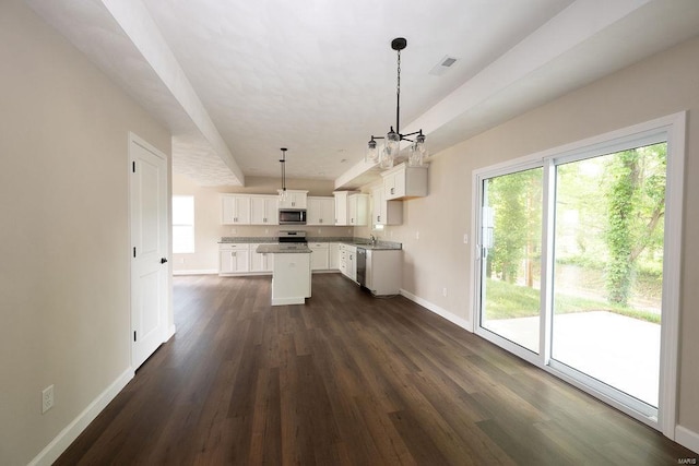 kitchen with a center island, dark hardwood / wood-style floors, white cabinets, hanging light fixtures, and appliances with stainless steel finishes