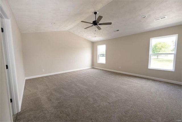 unfurnished room featuring carpet floors, lofted ceiling, ceiling fan, and a wealth of natural light