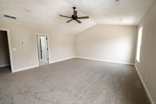 carpeted spare room with vaulted ceiling and ceiling fan