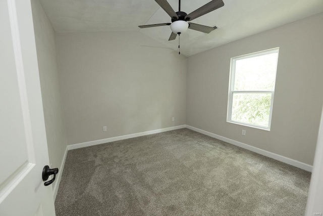 spare room featuring carpet, lofted ceiling, and ceiling fan