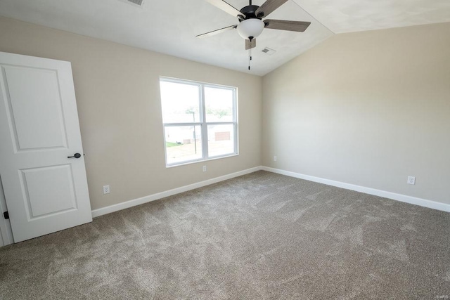 carpeted empty room with vaulted ceiling and ceiling fan