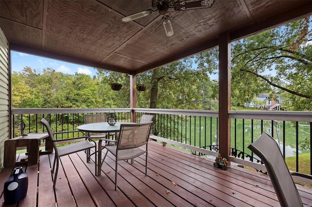 wooden deck with a lawn and ceiling fan