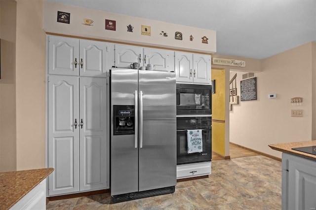 kitchen featuring black appliances and white cabinets