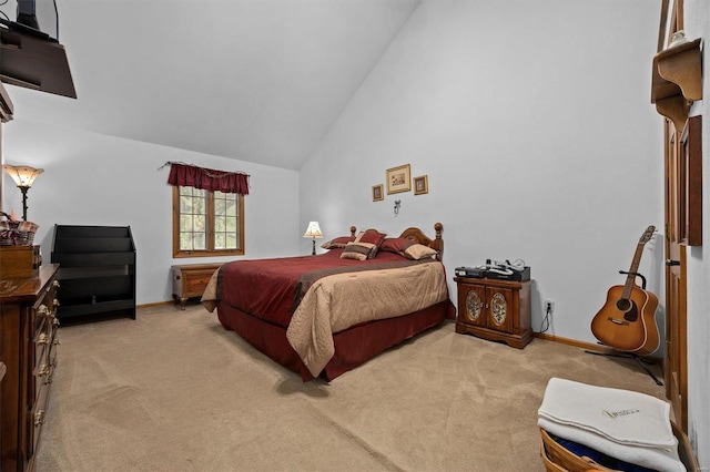 bedroom featuring light colored carpet and high vaulted ceiling