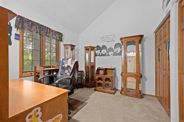 office area featuring light carpet and high vaulted ceiling