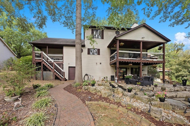 view of front of property featuring a deck, an outdoor living space, and a patio area